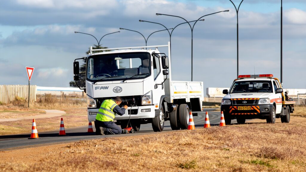 Qualified Service Technician performing Roadside Assistance on a FAW Freight Carrier